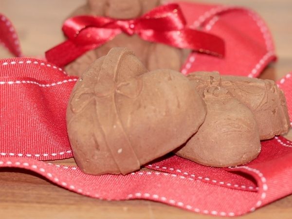 heart shaped chocolate on red bow