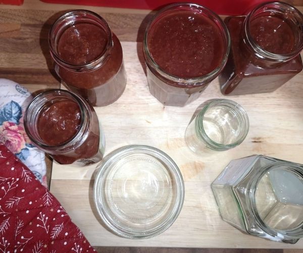 filling spicy strawberry jam jars